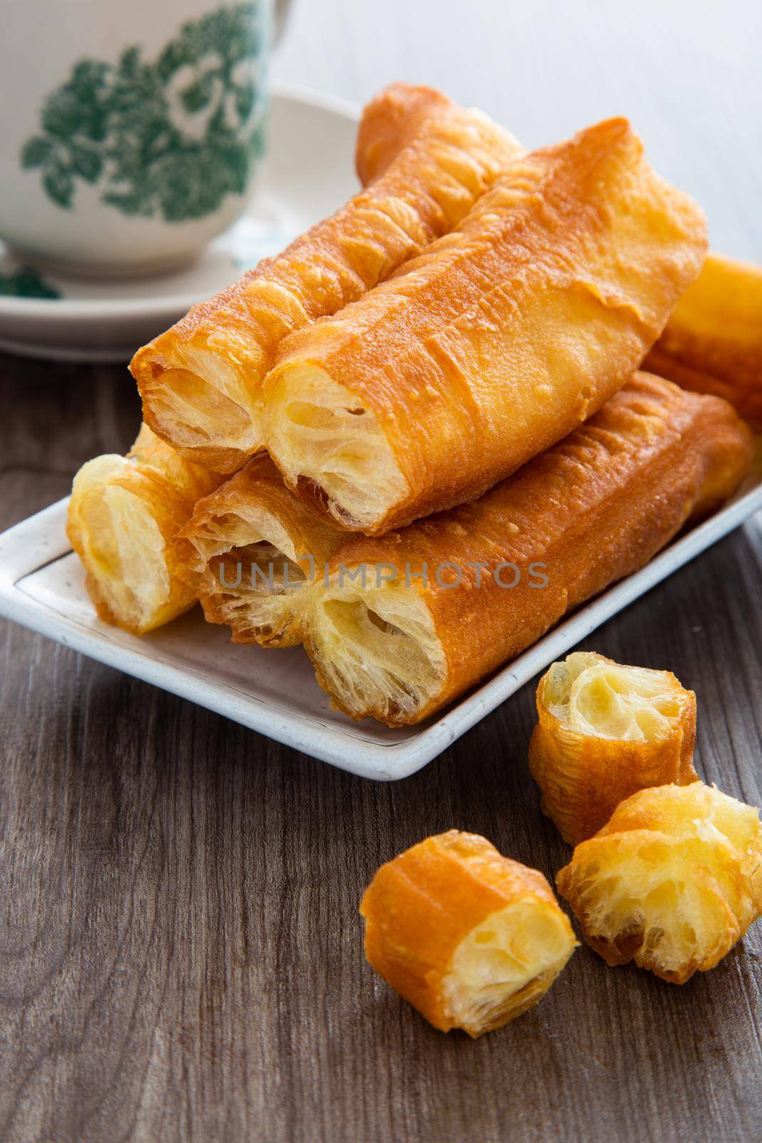 Youtiao (Chinese fried breadstick). Long golden brown deep fried dough strip.