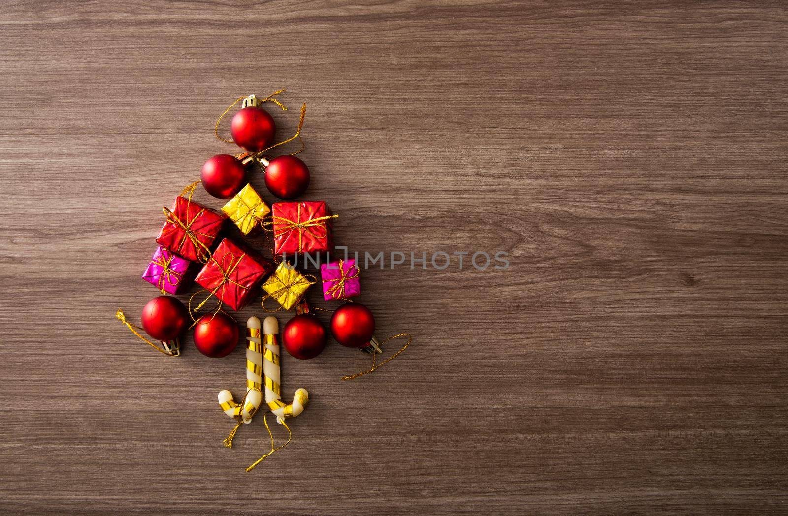 Christmas composition. Christmas gifts, decorations on wooden background. Flat lay by tehcheesiong