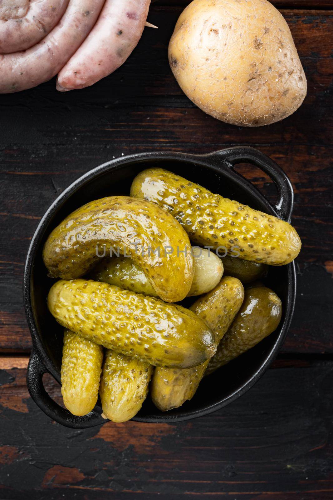 Pickled homemade cucumbers, pickles set, on old dark wooden table background, top view flat lay
