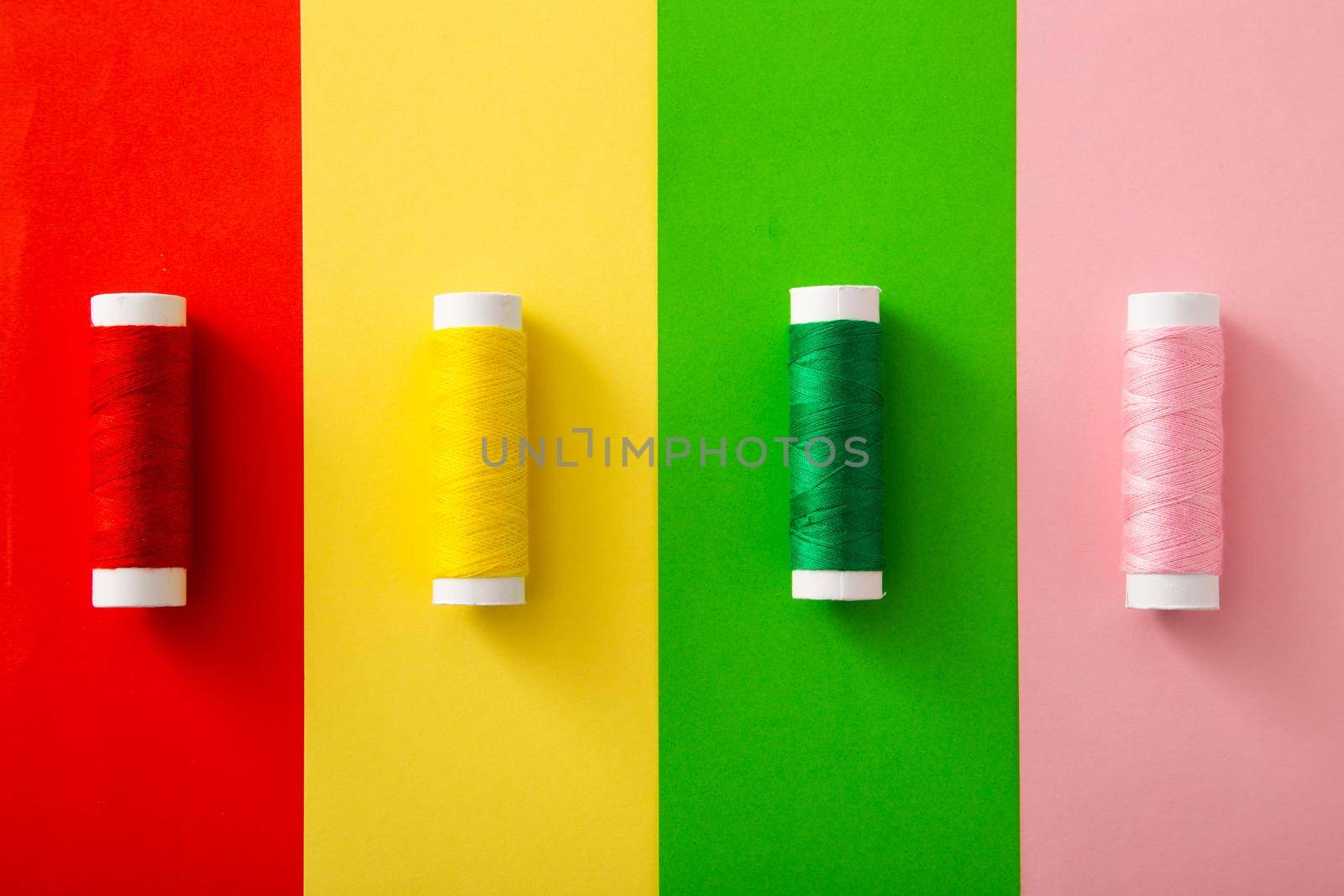 Colorful threads on colorful background (Flat lay)