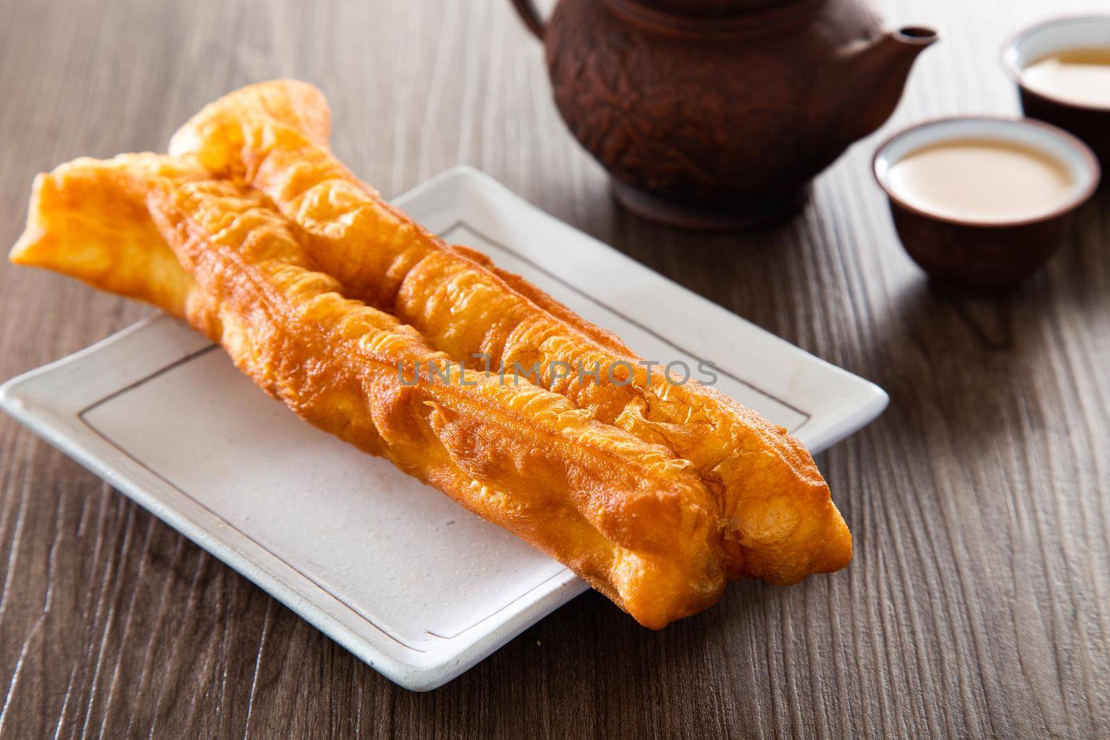 Youtiao (Chinese fried breadstick). Long golden brown deep fried dough strip.