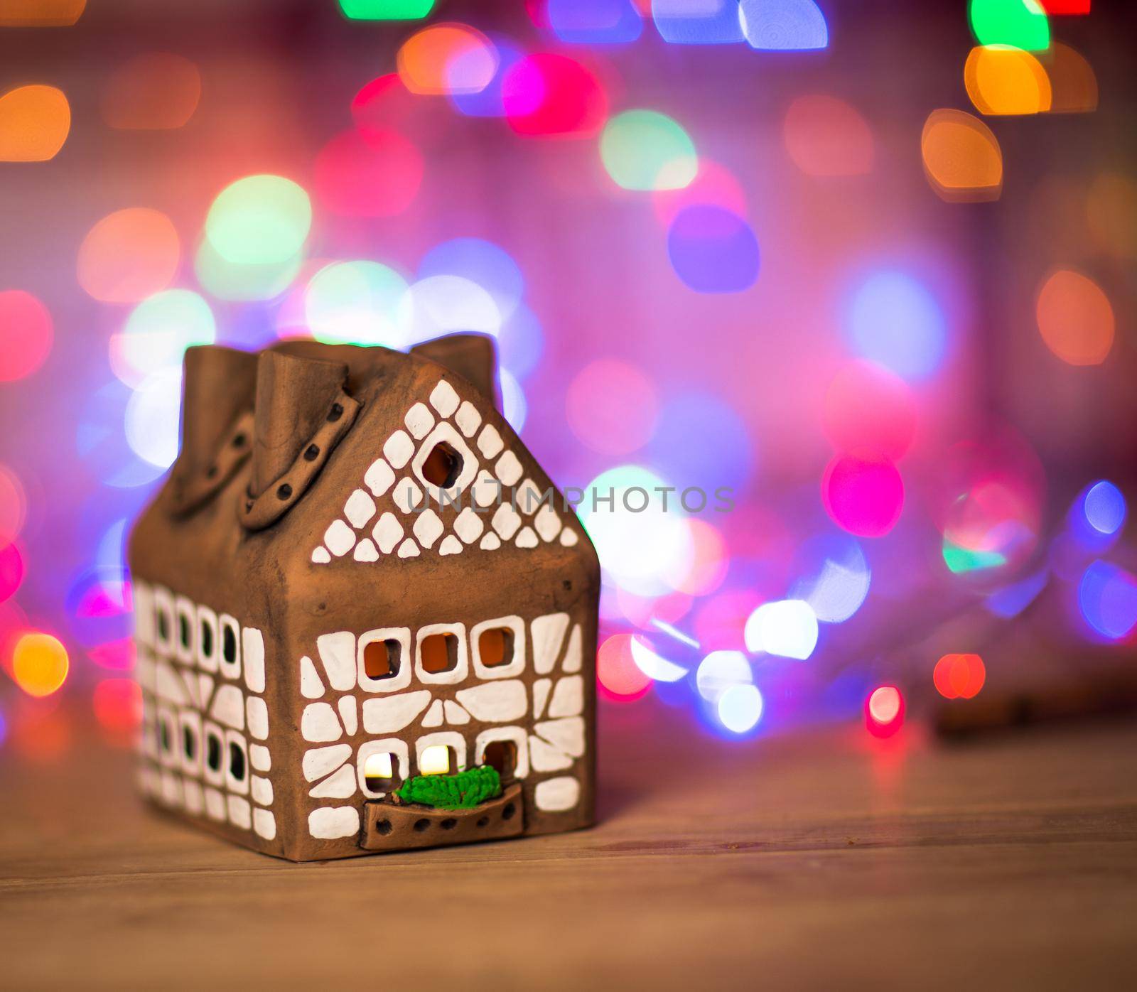fairy Christmas house cake with candle light inside, narrow depth of field and background lights