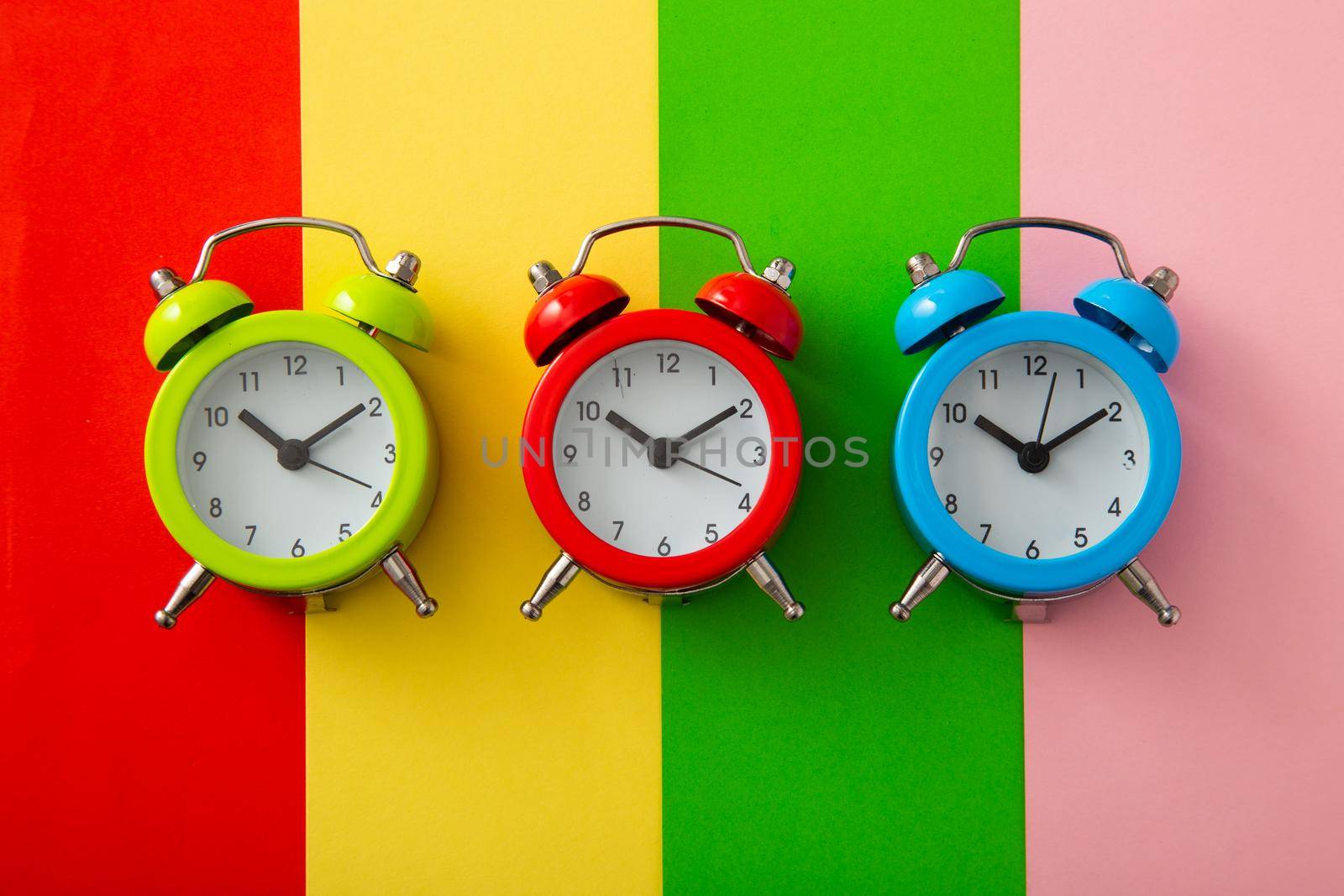 Colorful alarm clock on colorful background. by tehcheesiong