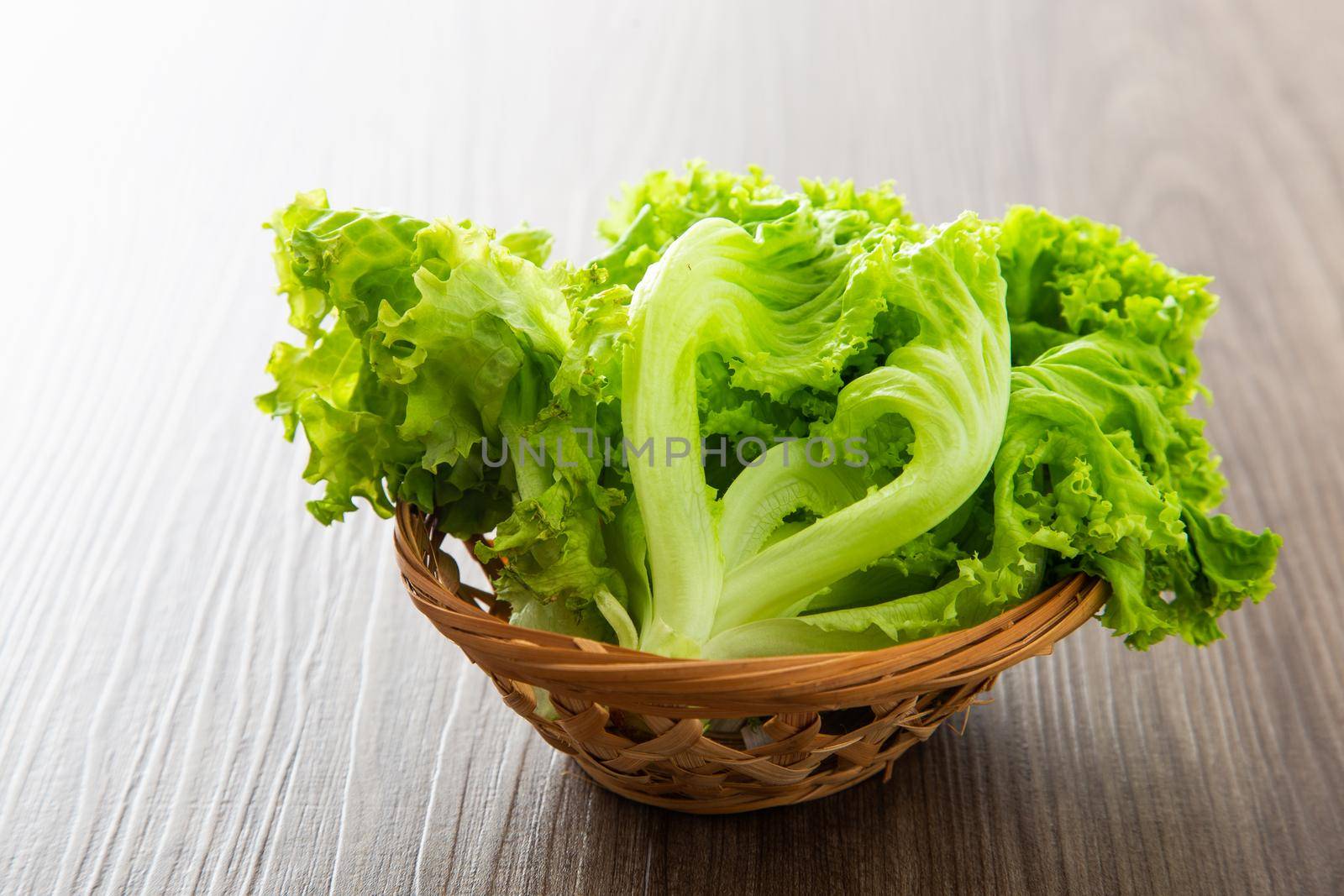 Fresh lettuce vegetable on a wooden table by tehcheesiong