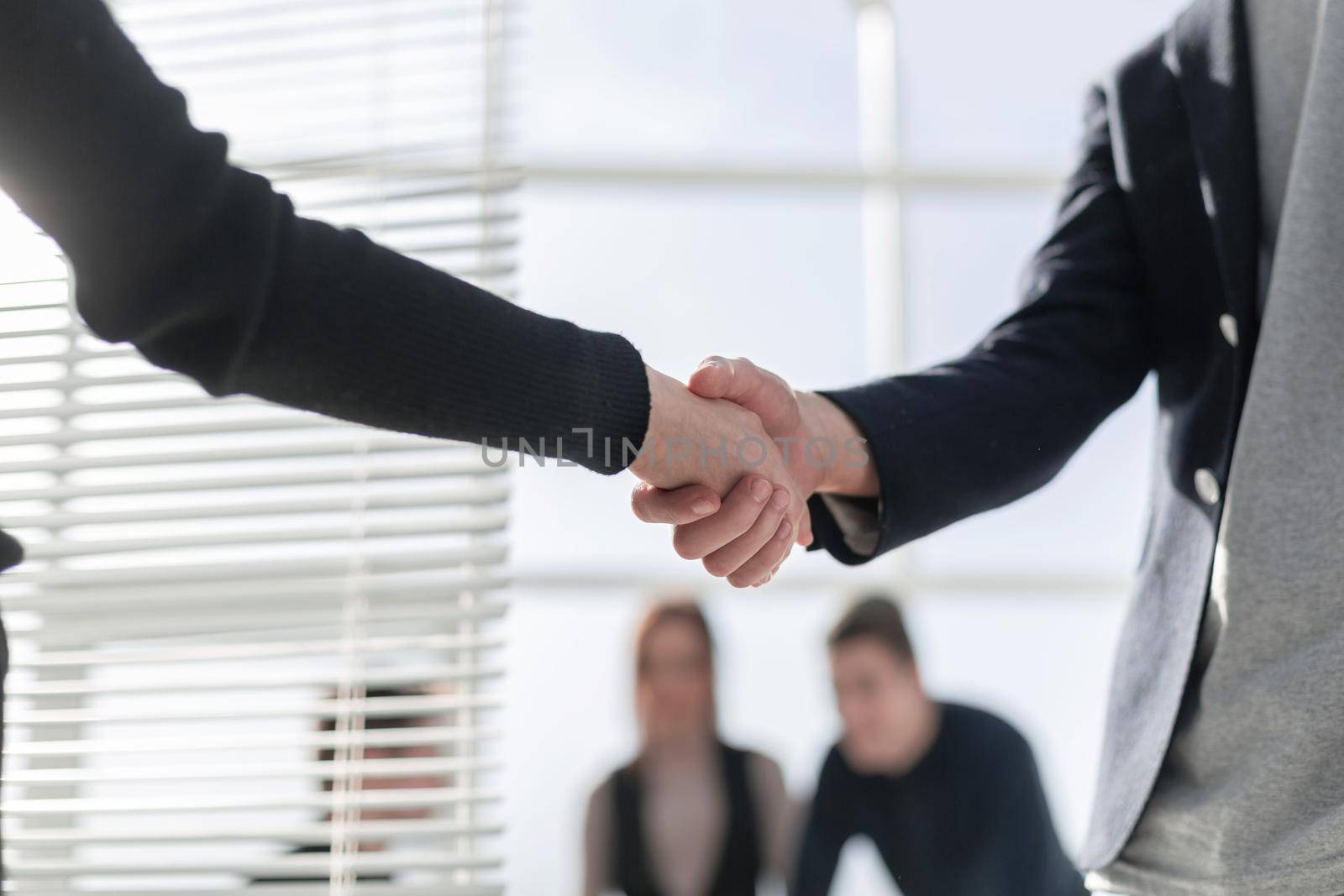 Business partnership meeting concept. Image businessmans handshake. Successful businessmen handshaking after good deal. Horizontal, blurred background