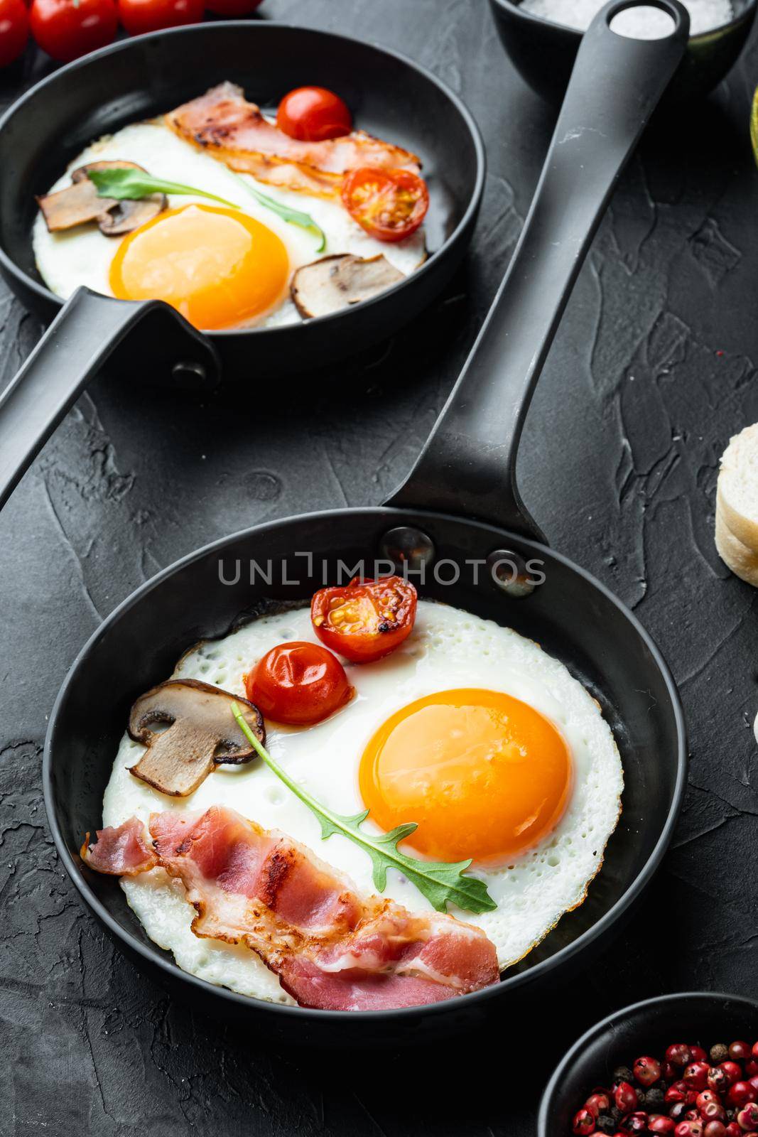 Fried Egg with ingredient in cast iron frying pan, on black background