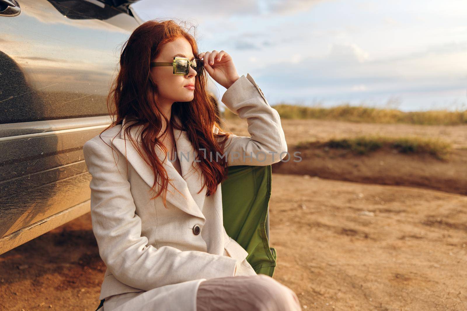 woman wheat countryside landscape freedom near the car endless field. High quality photo