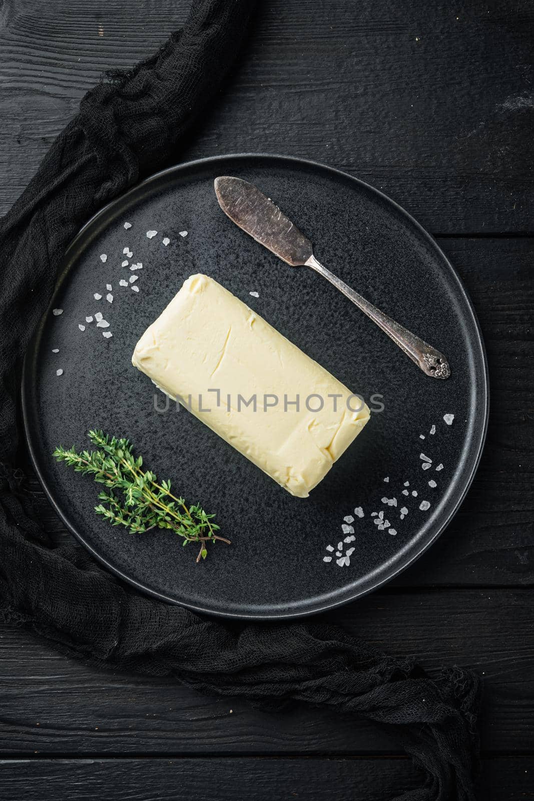 White butter fresh brick, on black wooden table background, top view flat lay