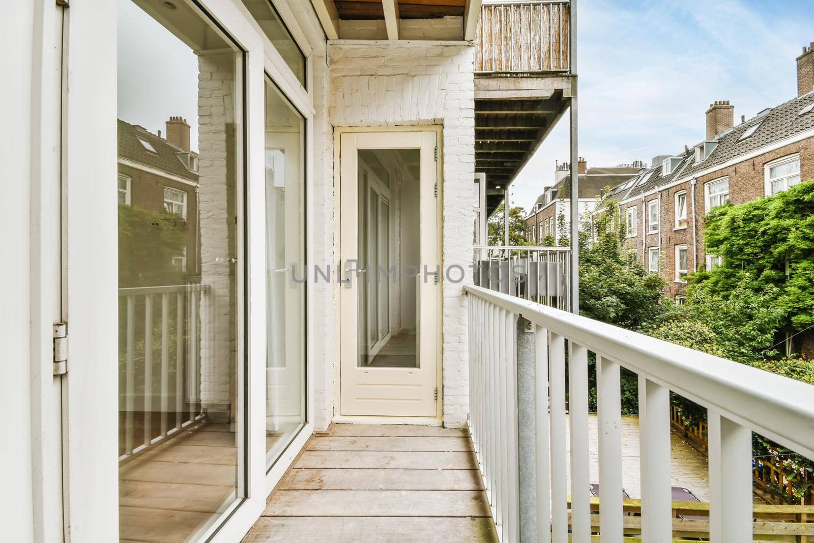 Attractive long narrow balcony with wooden handrails