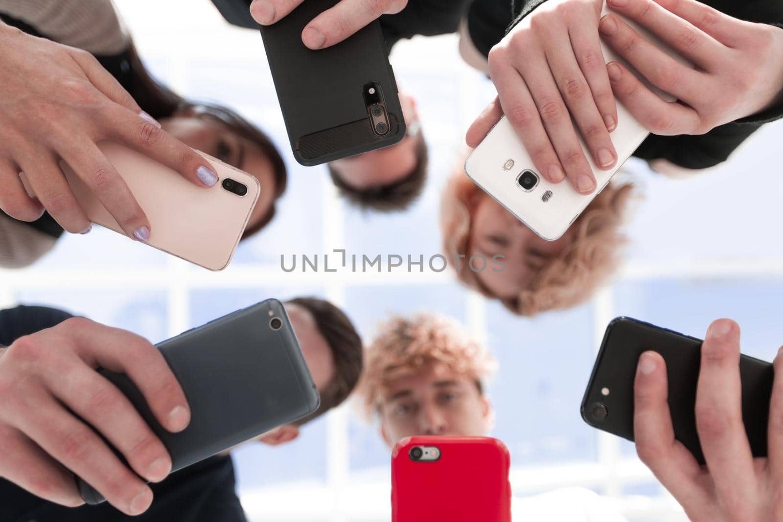 Group of businessman hold smartphones. bottom view by asdf