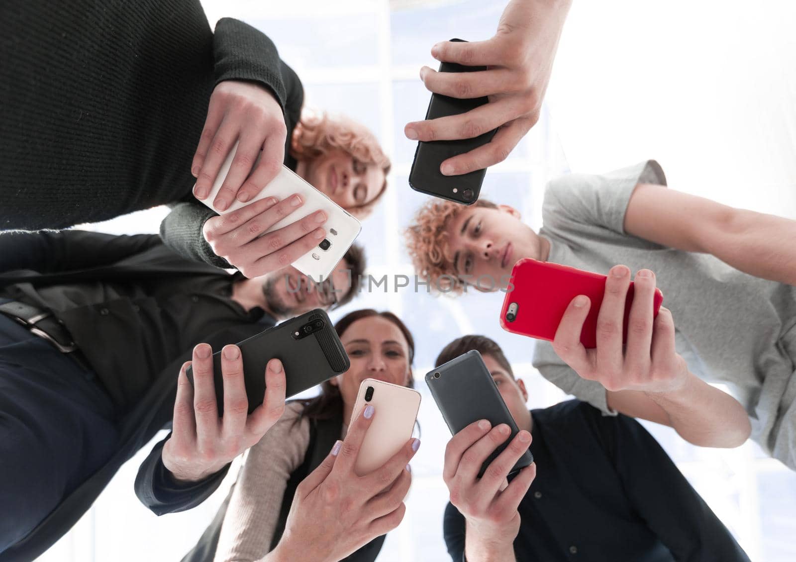 Group of businessman hold smartphones. bottom view by asdf