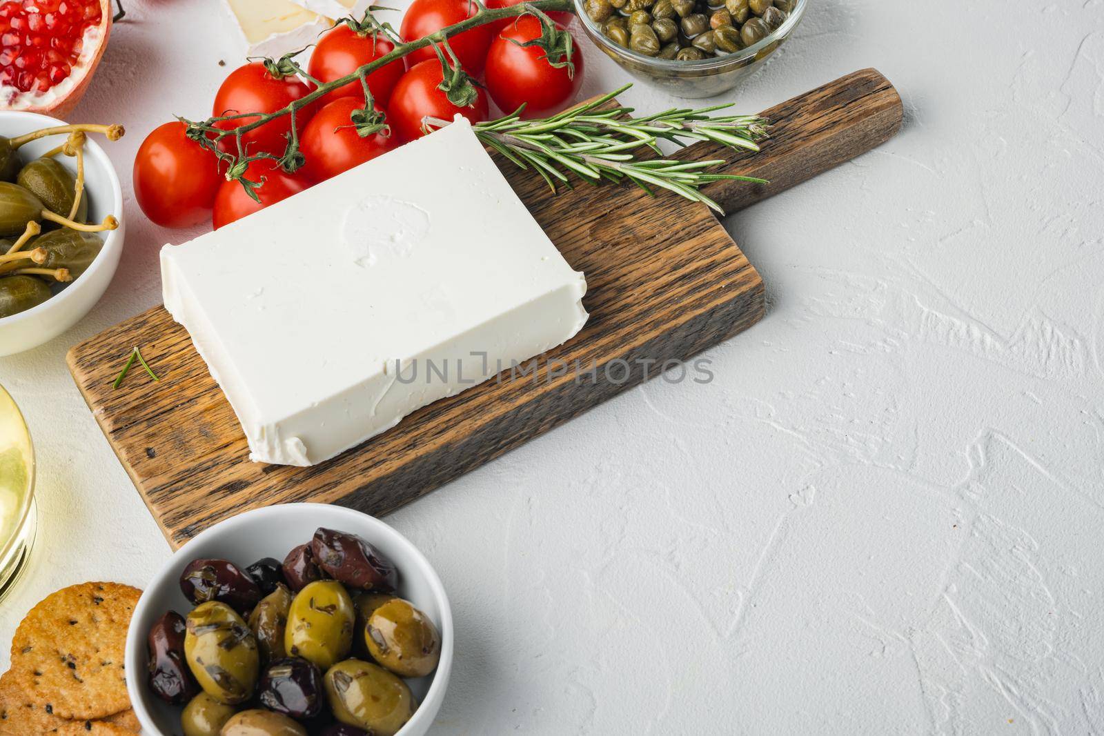 Ingredients for traditional greek salad set, on white background with copy space for text
