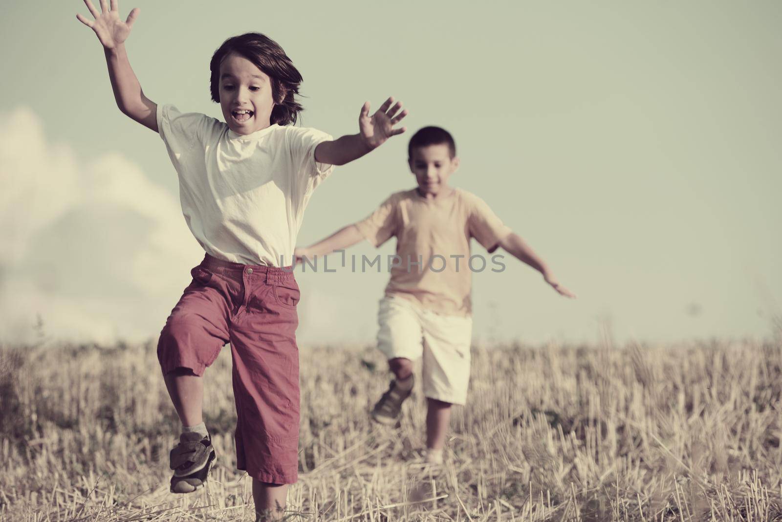 Happy children running on beautiful field