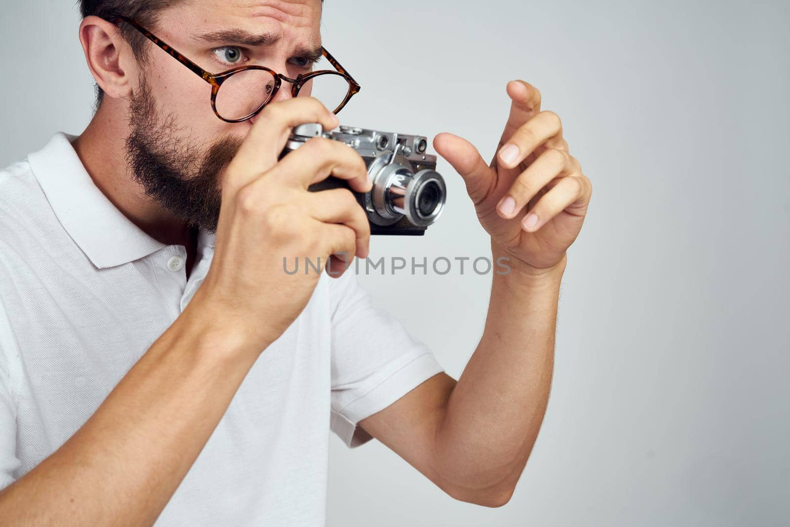 man holding camera professional photographer home light background. High quality photo