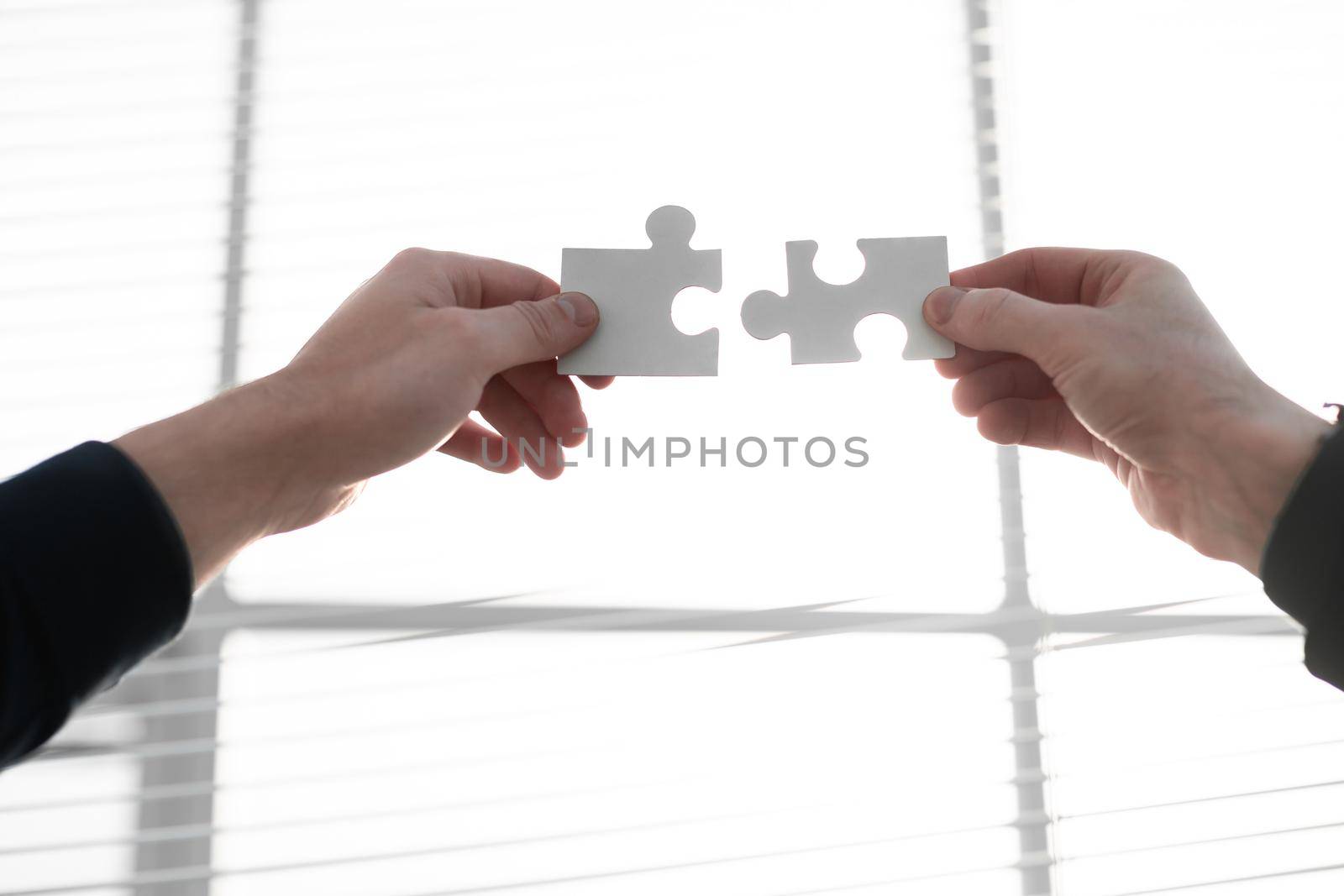 Closeup hand connecting jigsaw puzzle with, business solutions, success and strategy concept