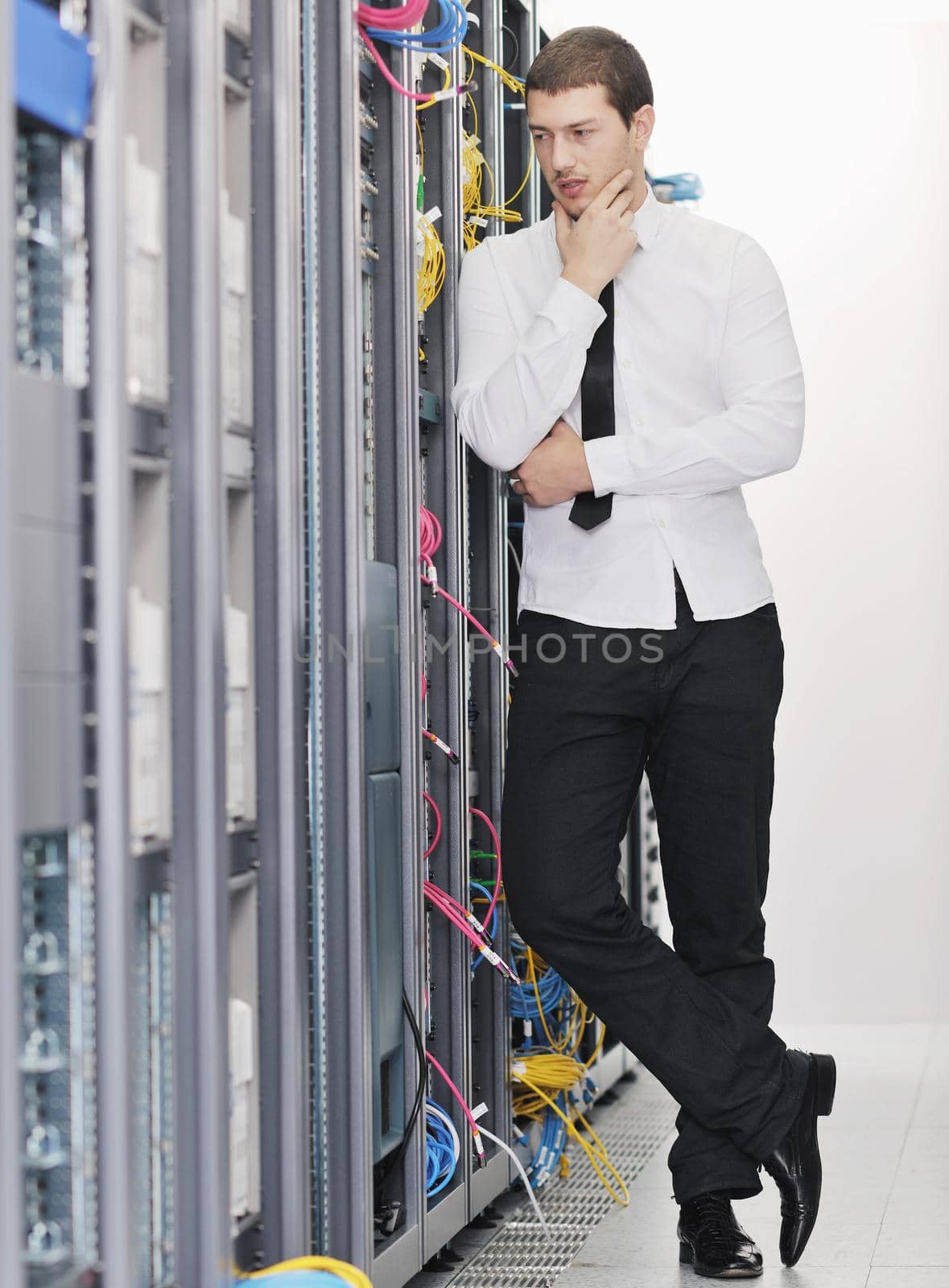 young handsome business man it  engeneer in datacenter server room