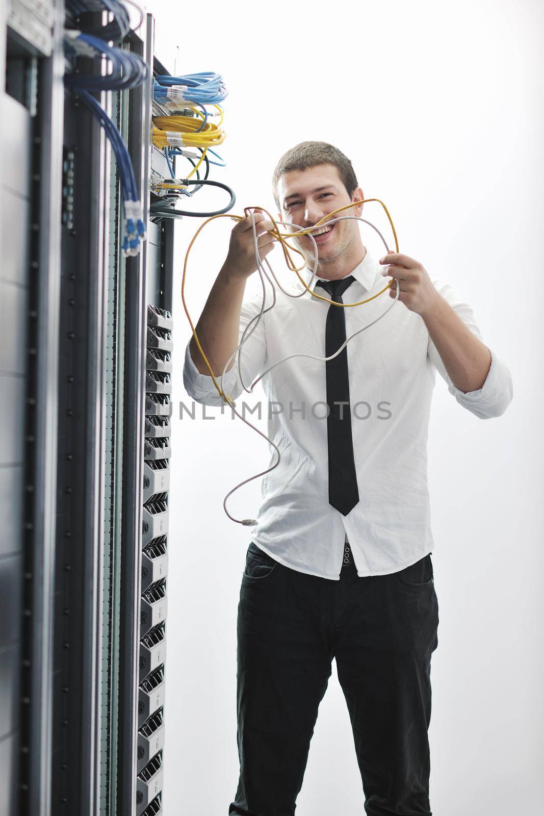 young handsome business man  engeneer in datacenter server room 