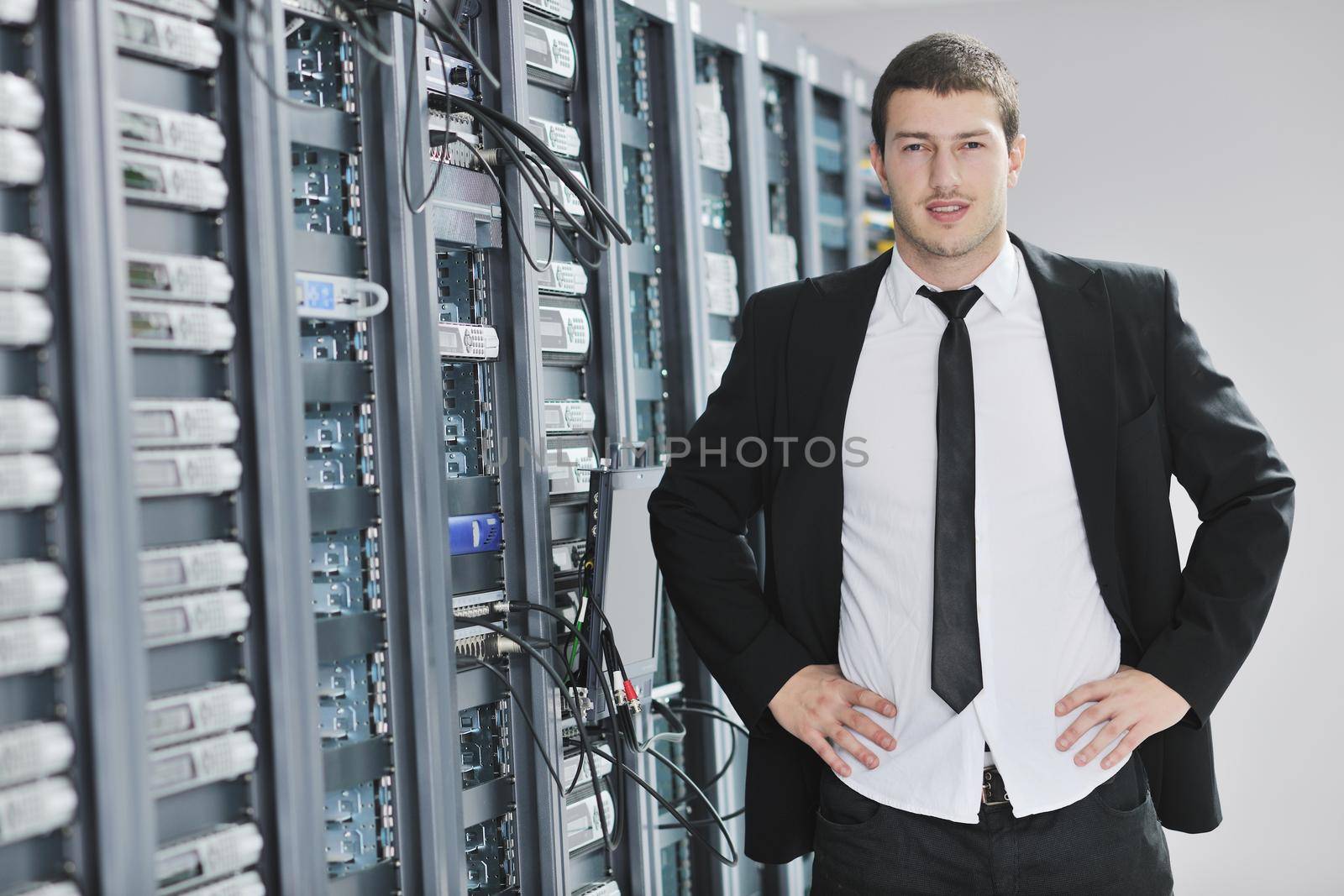 young engeneer in datacenter server room by dotshock