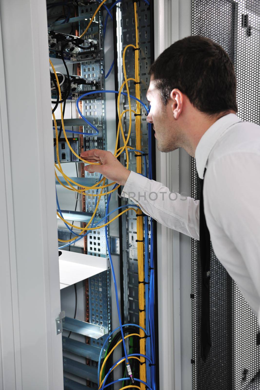 young handsome business man  engeneer in datacenter server room 