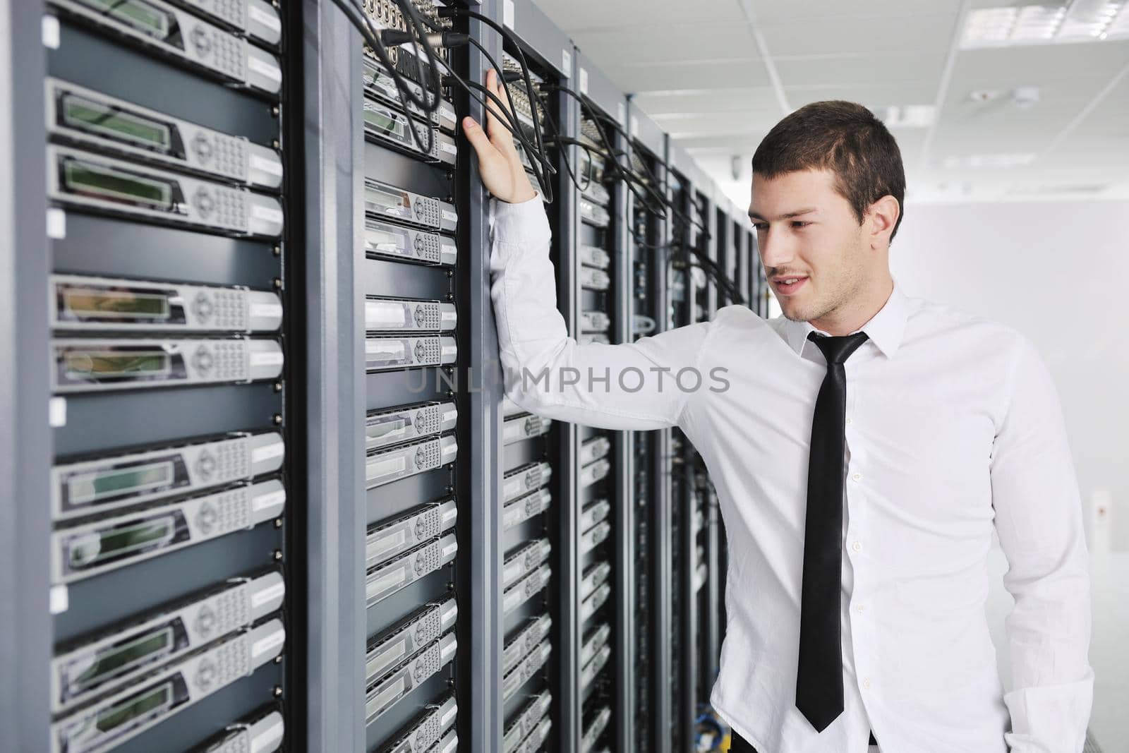 young engeneer in datacenter server room by dotshock