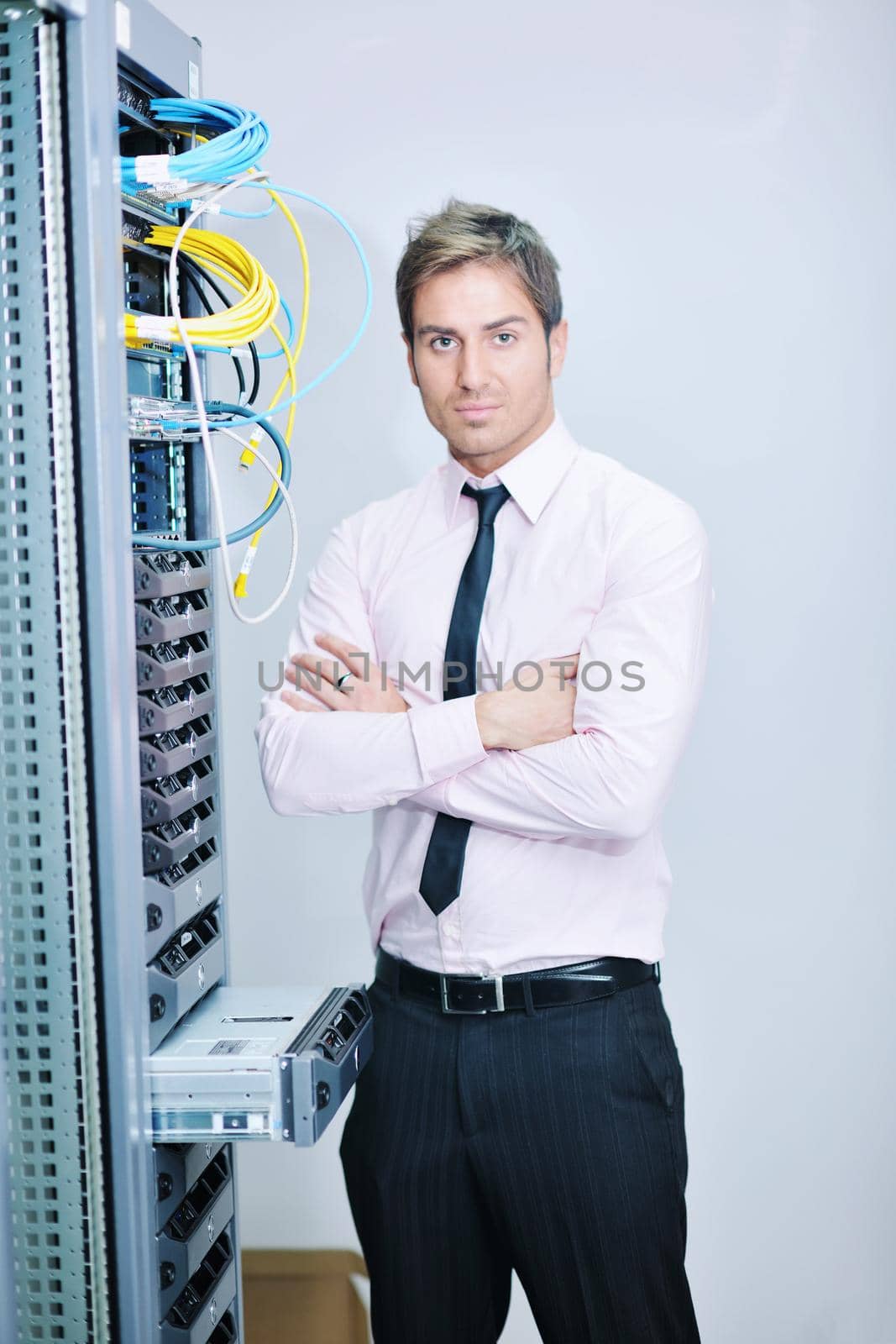 young handsome business man  engeneer in datacenter server room