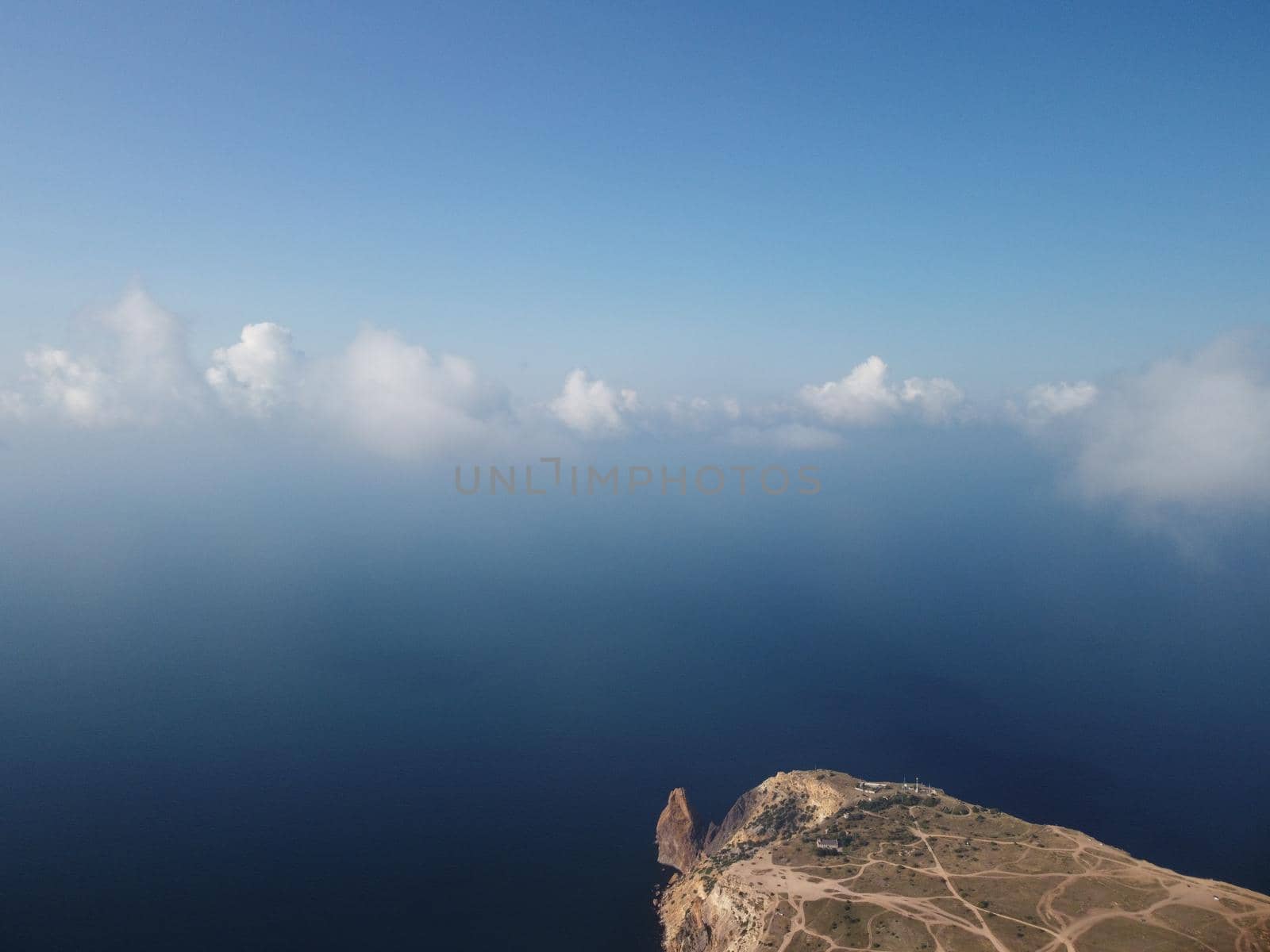 Abstract aerial nature summer ocean sunset sea and sky background. Small waves on clear water surface in motion blur with bokeh lights from sunrise. Holiday, vacation and recreational concept by panophotograph