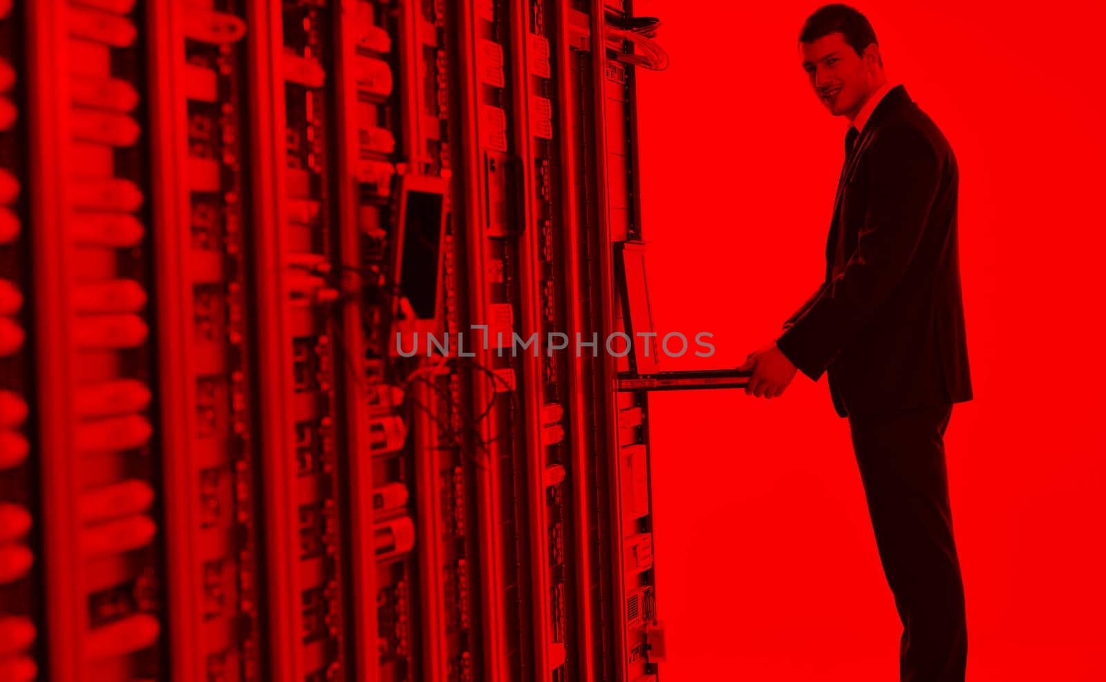 young engeneer in datacenter server room by dotshock