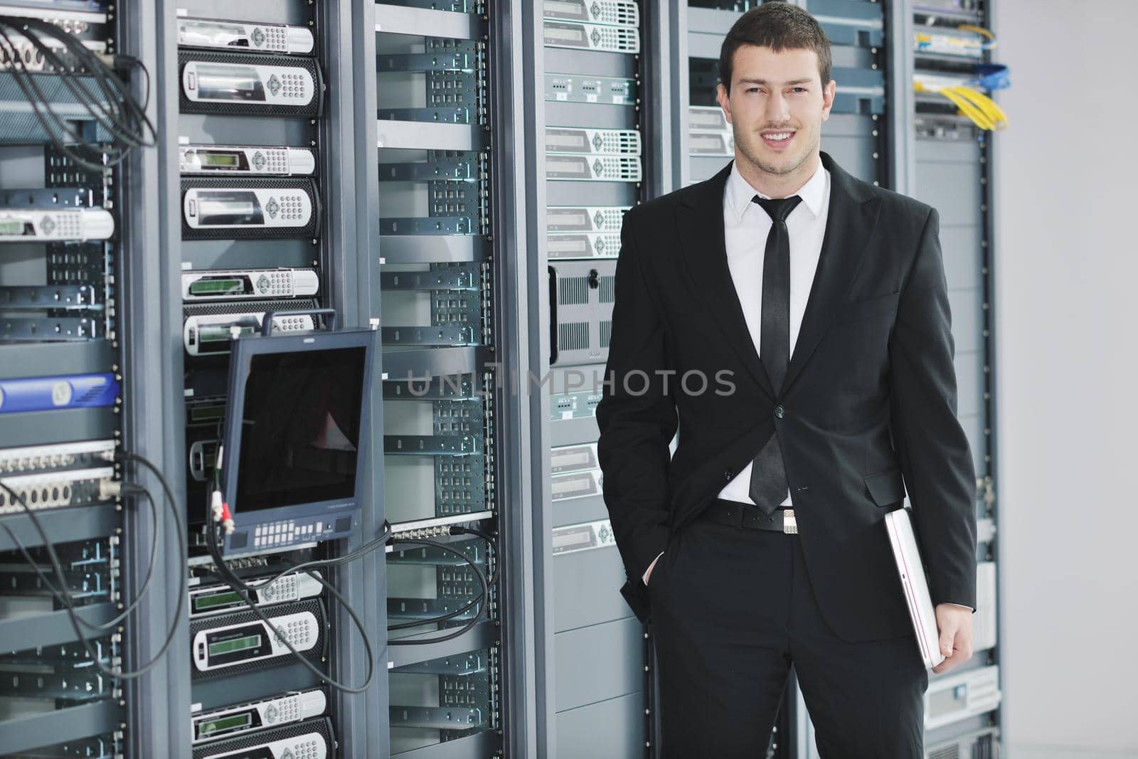 young handsome business man  engeneer in datacenter server room 