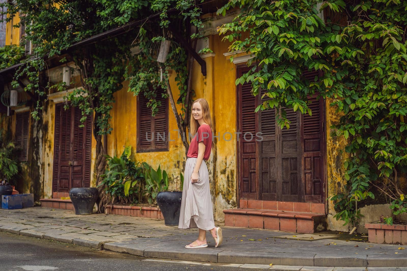 Woman tourist on background of Hoi An ancient town, Vietnam. Vietnam opens to tourists again after quarantine Coronovirus COVID 19 by galitskaya