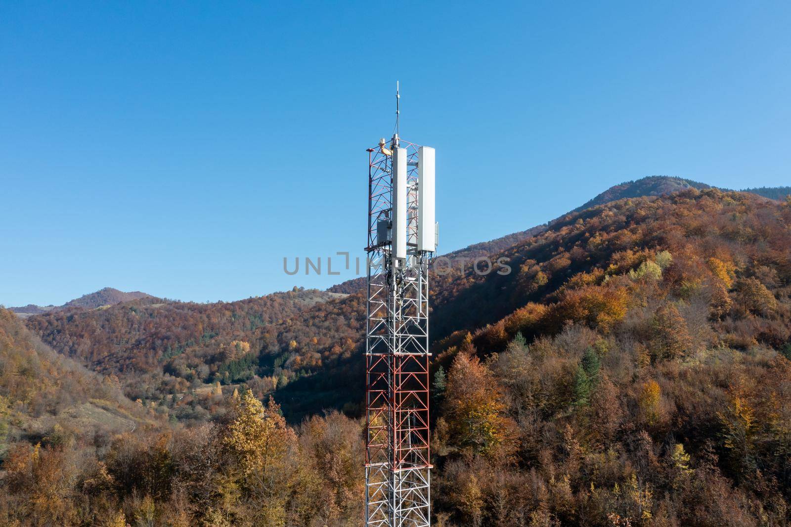 Telecommunications antenna tower in the morning. bright sunshine and blue sky with clouds. Transmitting antenna pairs. High quality photo