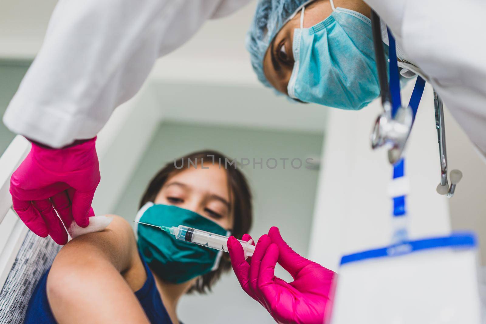 Little cute child with mask getting injection