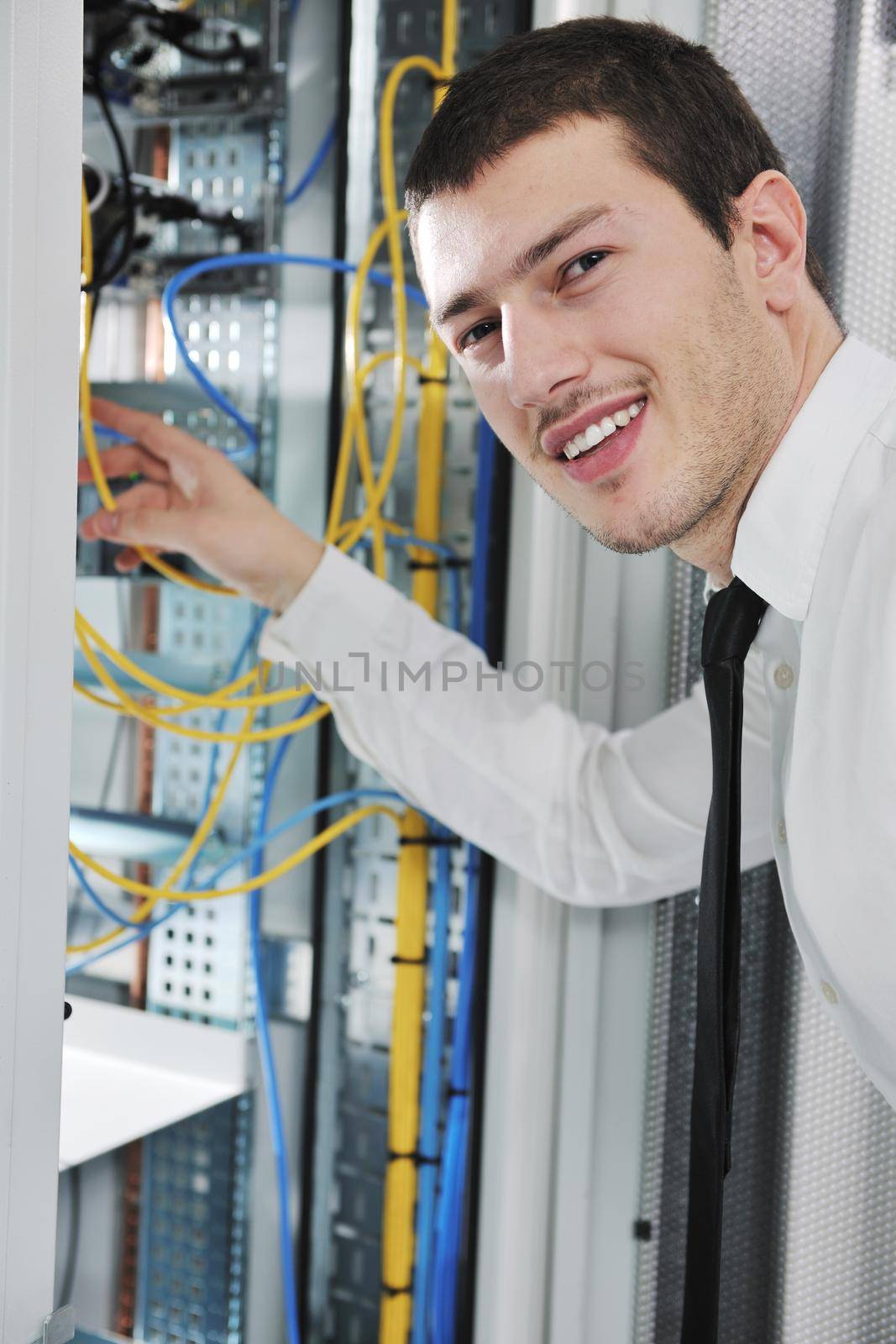 young engeneer in datacenter server room by dotshock