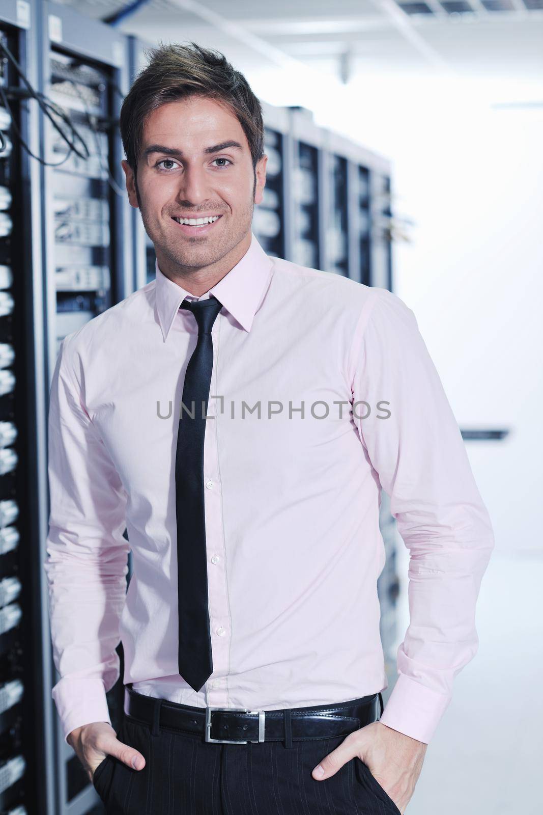 young handsome business man  engeneer in datacenter server room