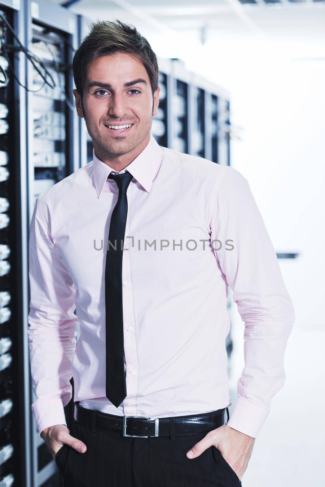 young handsome business man  engeneer in datacenter server room