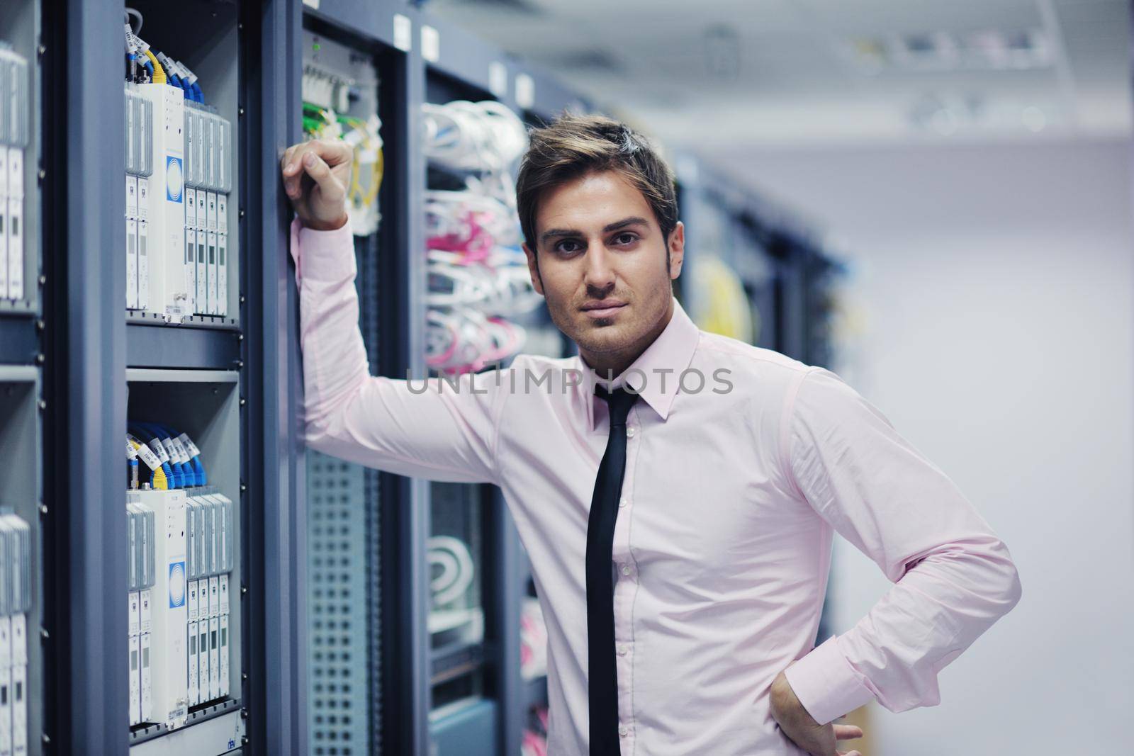 young it engeneer in datacenter server room by dotshock