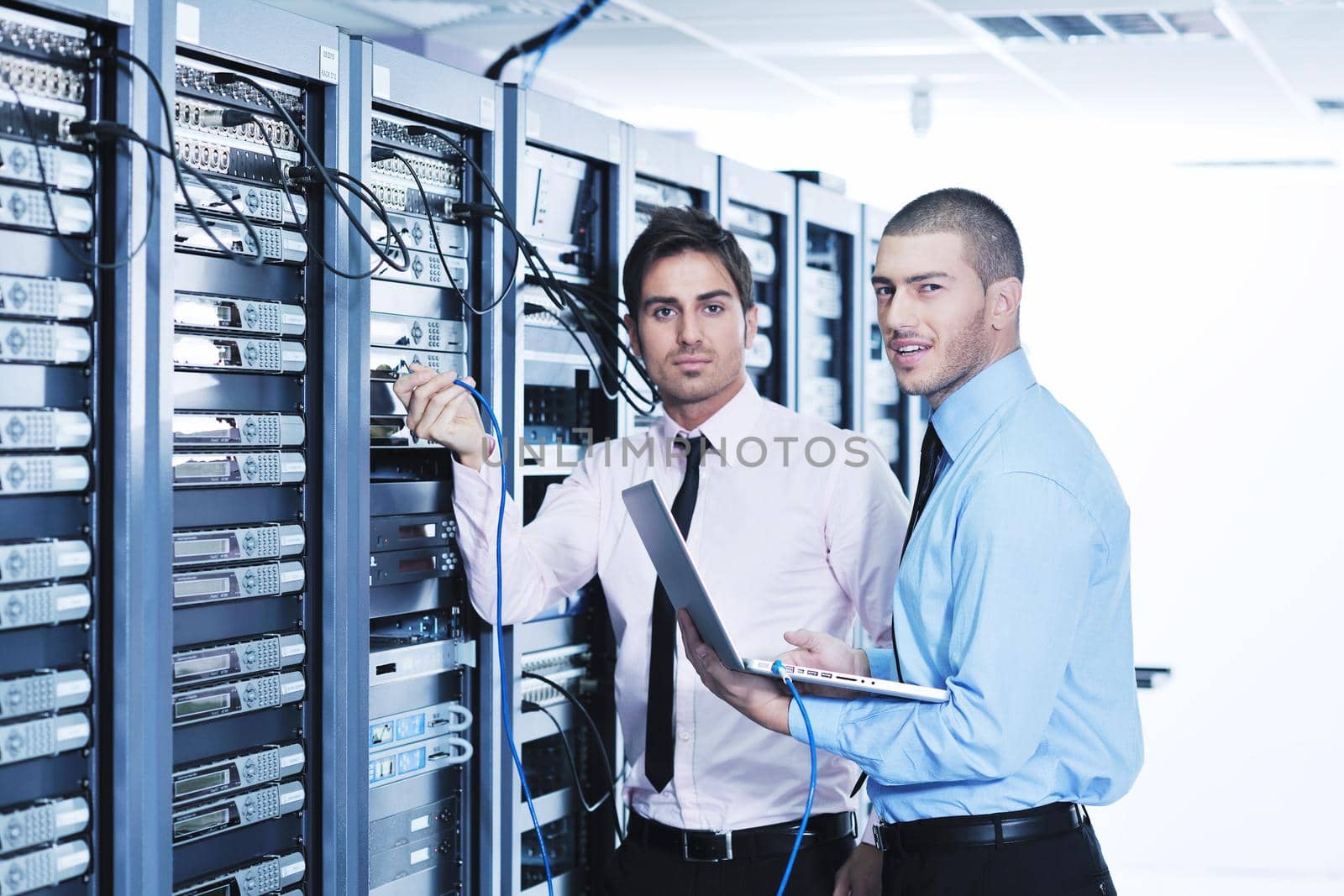 group of young business people it engineer in network server room solving problems and give help and support