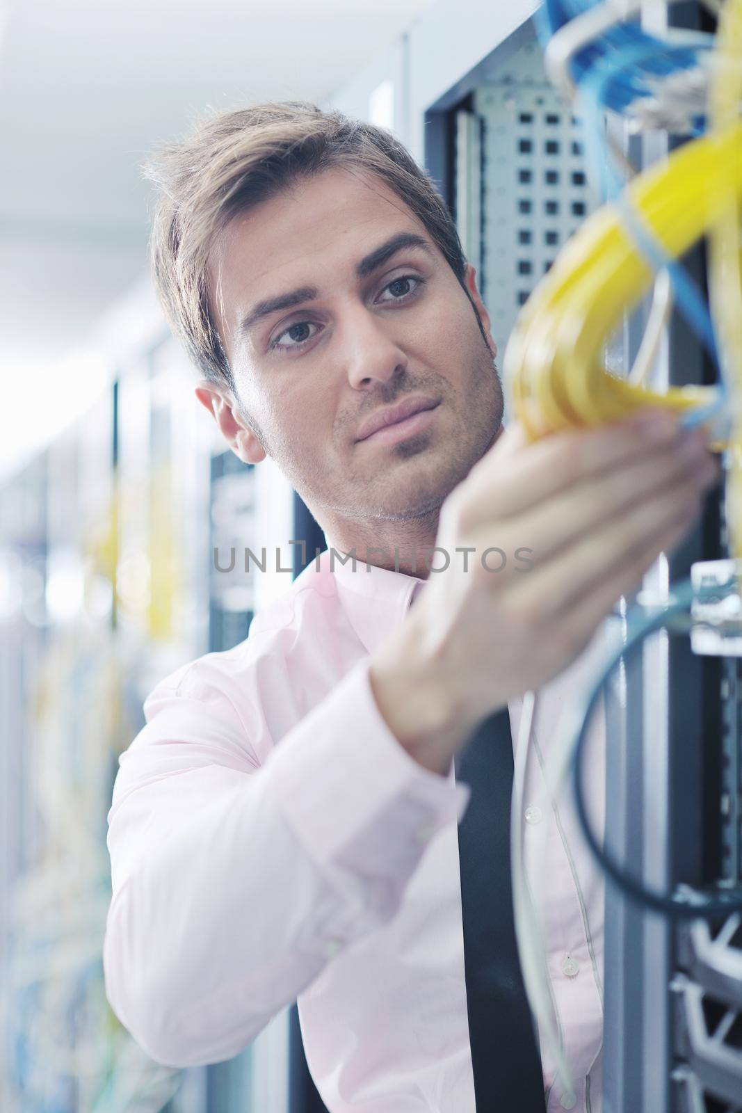 young it engeneer in datacenter server room by dotshock