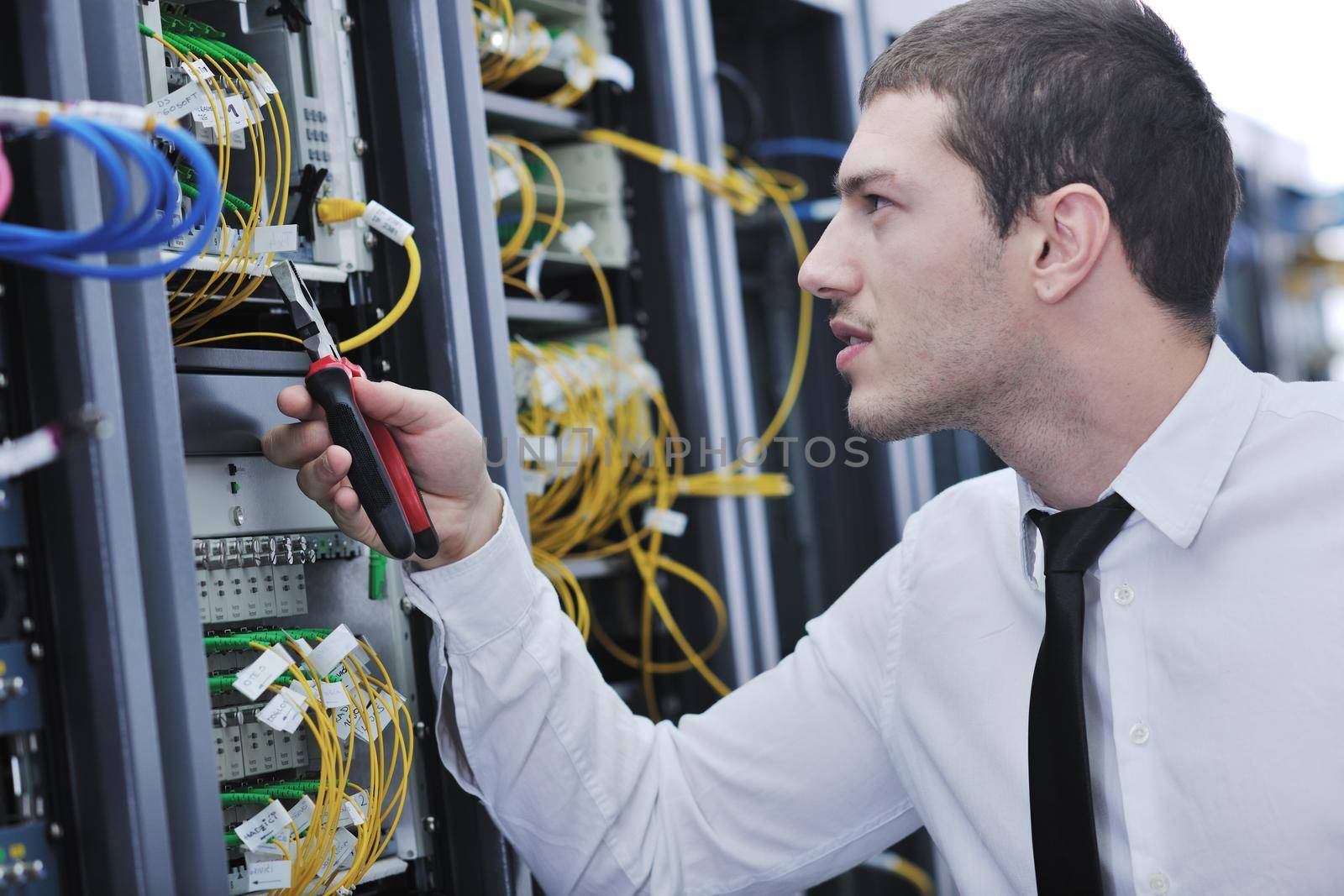 young handsome business man  engeneer in datacenter server room 