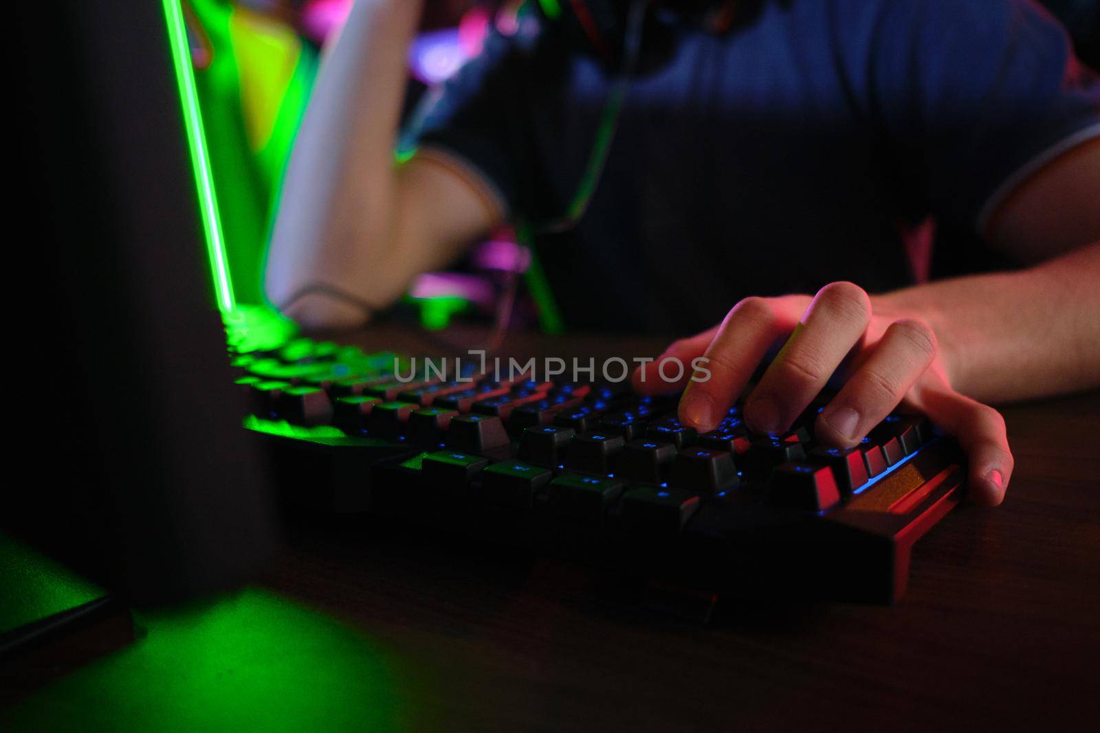 Close up view of professional players hands laying on gaming keyboard in gaming club or cyber arena