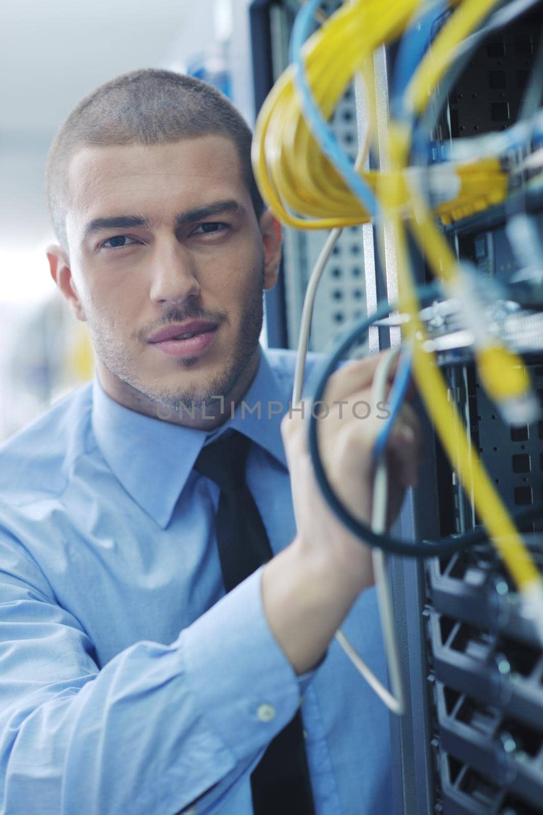 young handsome business man  engeneer in datacenter server room