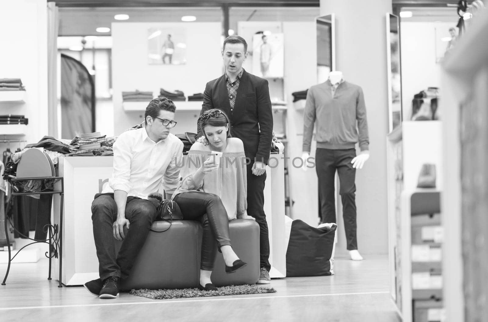 group of Friends On Shopping Walk On Shopping Centre using a mobile phone for ideas