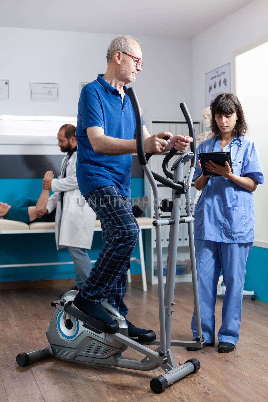 Senior man doing physical activity with electrical bicycle by DCStudio