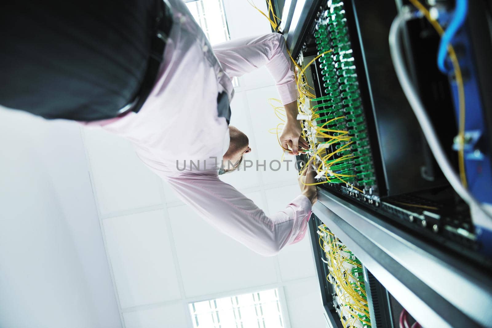 young handsome business man  engeneer in datacenter server room