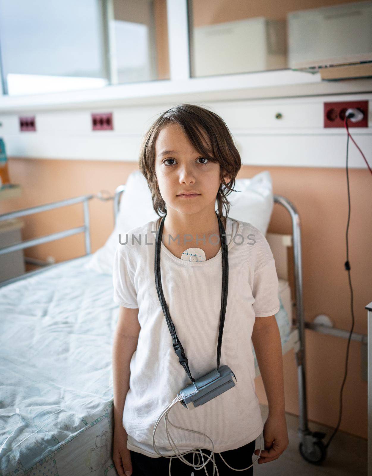 Little cute boy in hospital at bed indoors