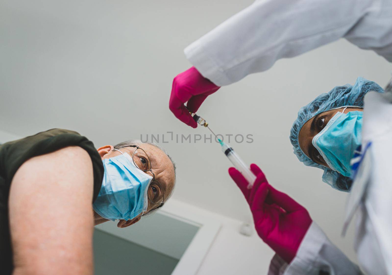 Senior old woman in hospital getting vaccine 2021