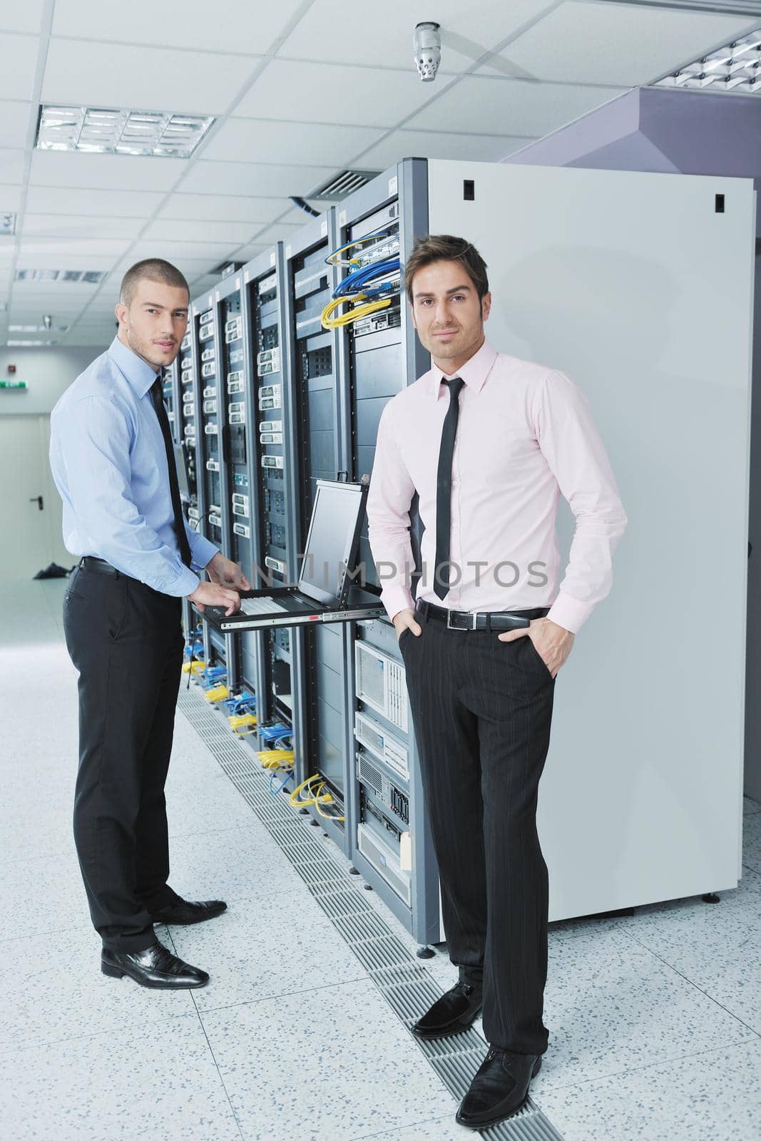 group of young business people it engineer in network server room solving problems and give help and support