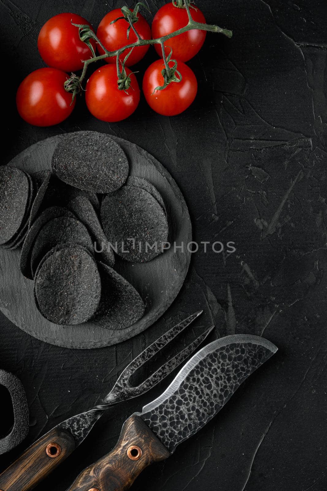 Cheese and chive potato crisp snack set, on black stone background, top view flat lay