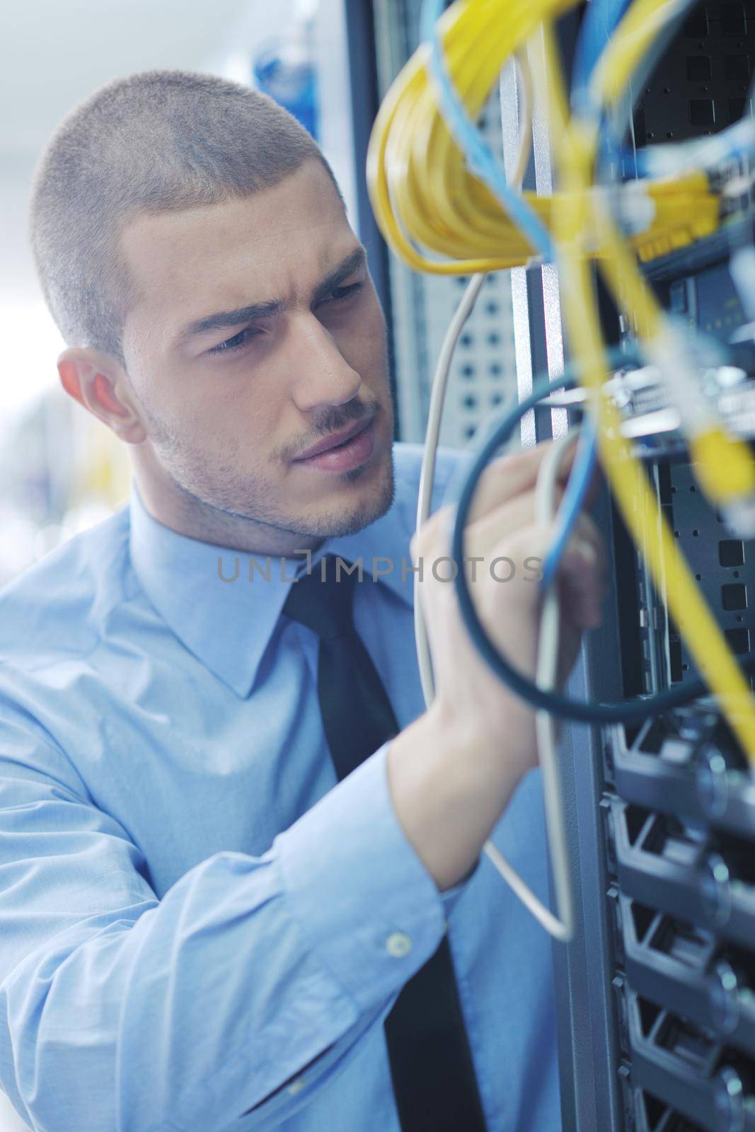 young handsome business man  engeneer in datacenter server room