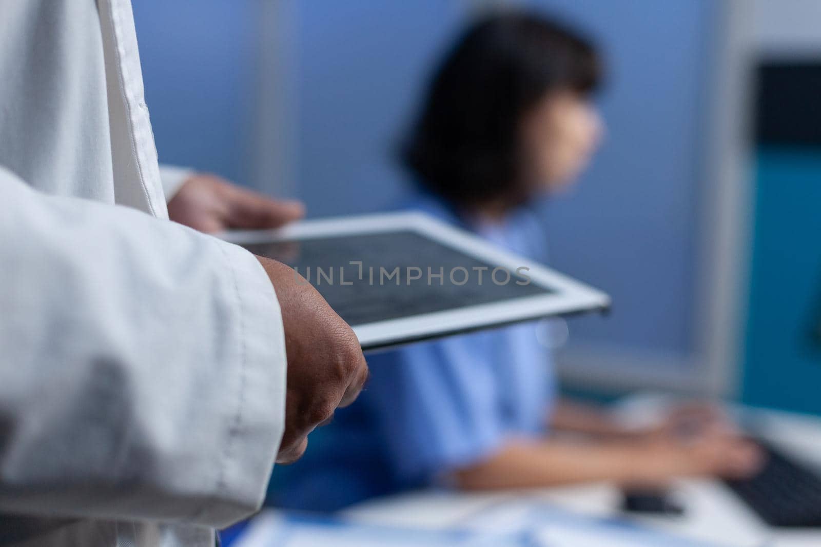 Close up of doctor holding modern tablet for osteopathy diagnosis by DCStudio