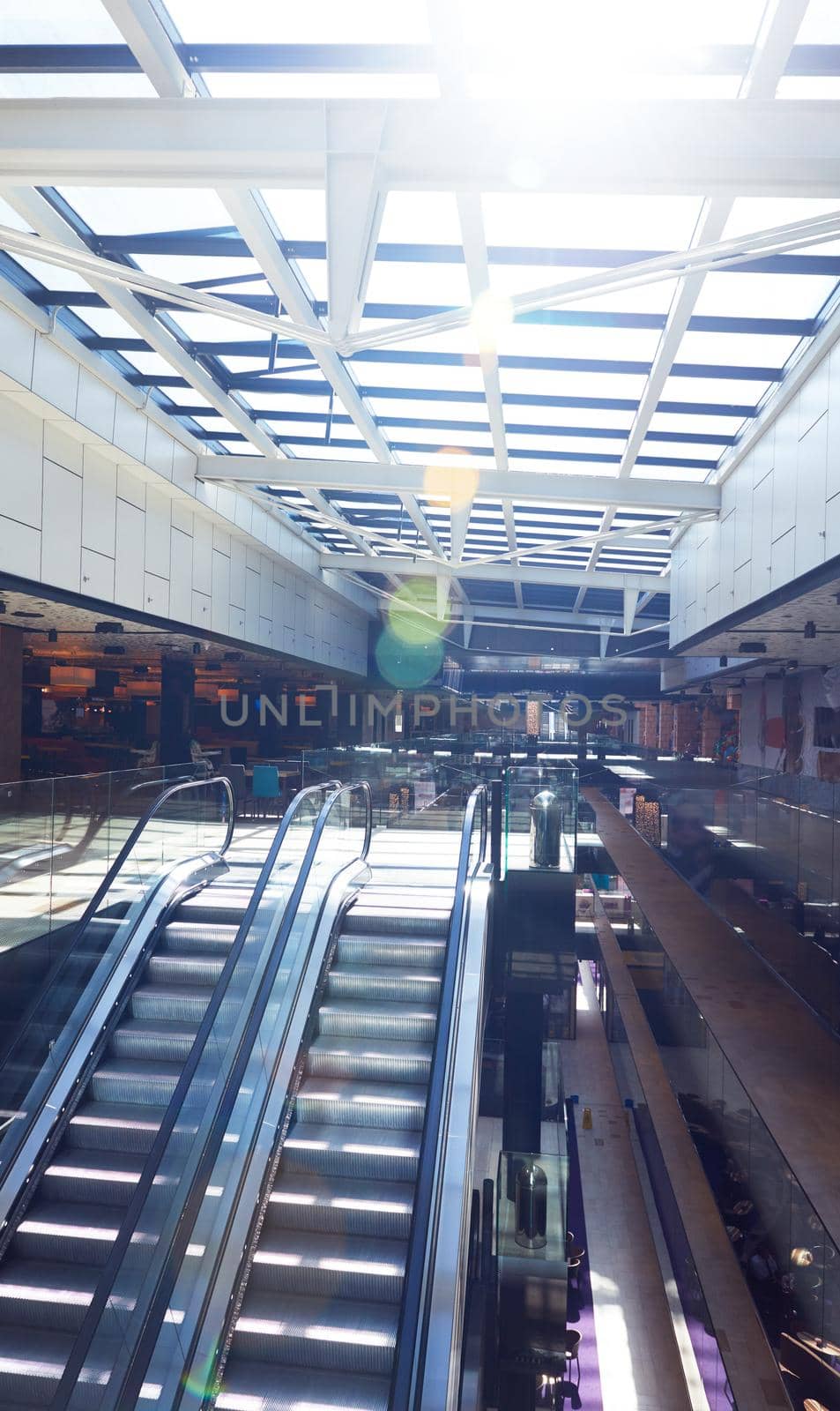 modern shopping mall store  interior escalator with lens flare